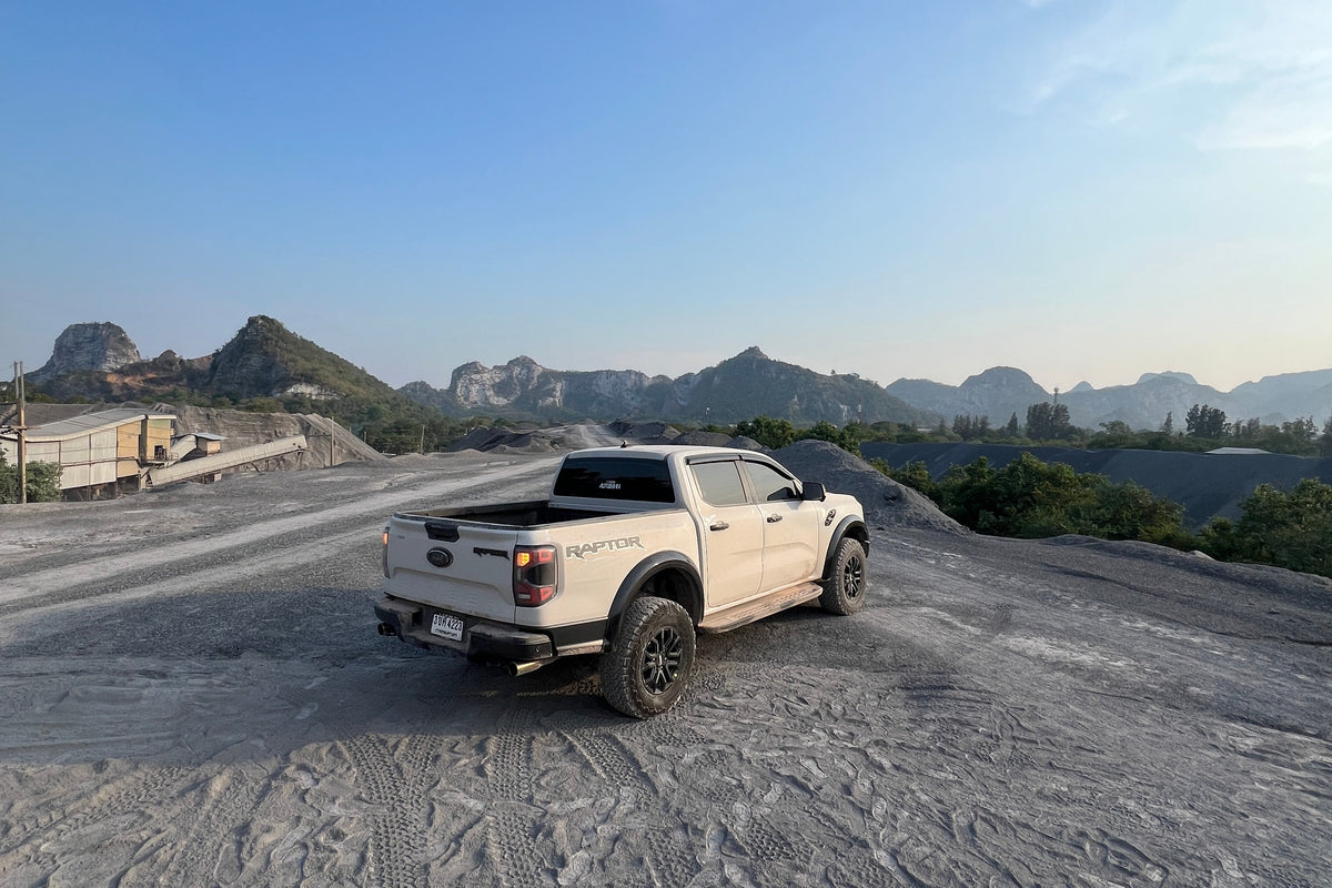 Car on a textured road with a clear blue sky